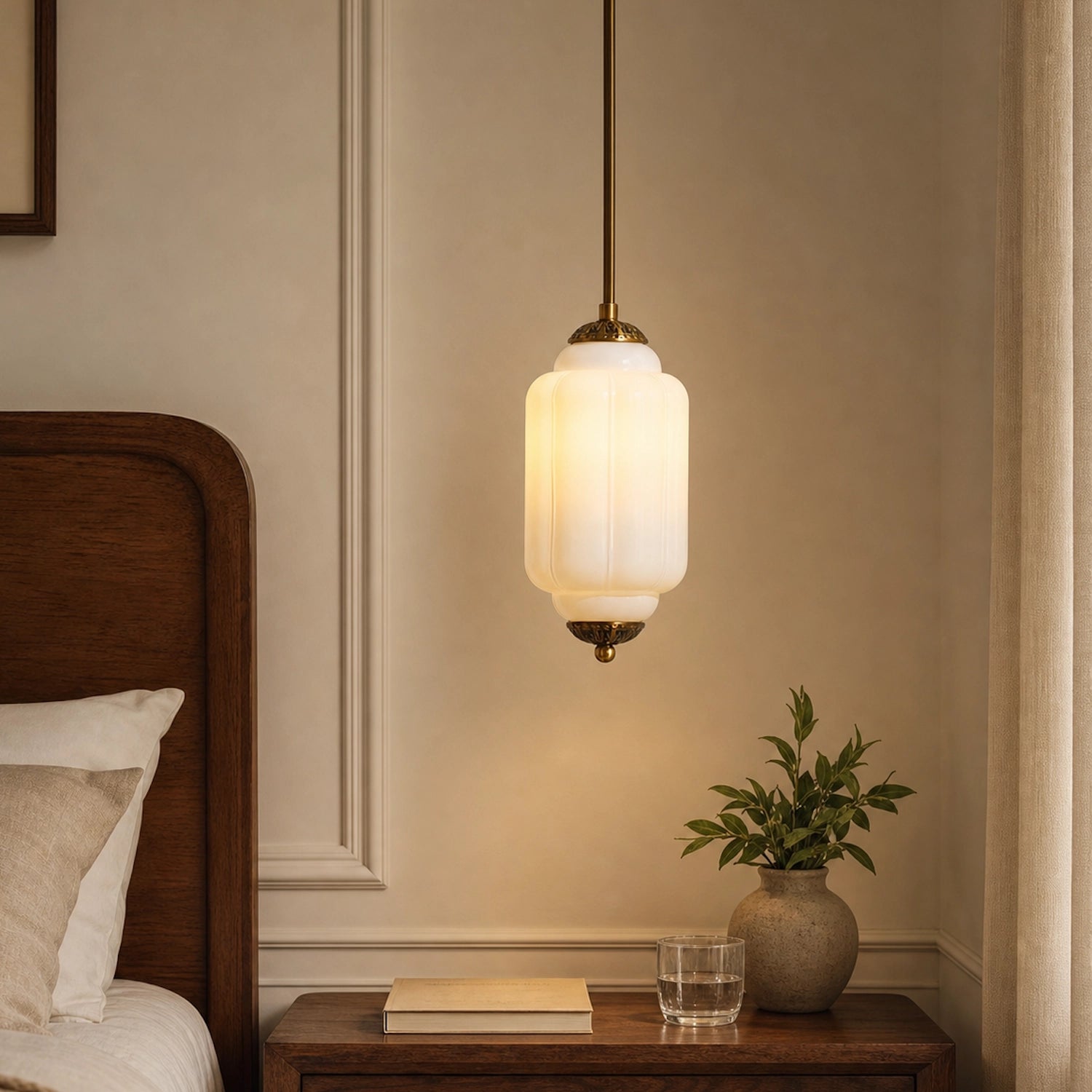 White milk glass pendant light fixture on a wall above a wooden nightstand with a plant
