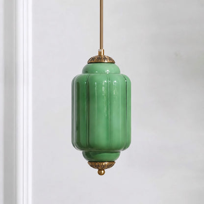 Green milk glass pendant light with brass base on a white background