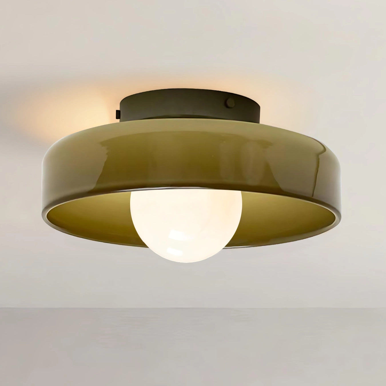 Ceiling light fixture with a greenish-brown shade on a plain background
