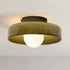 Ceiling light fixture with a greenish-brown shade on a plain background